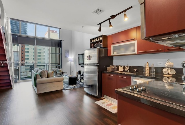 244 Biscayne Blvd Unit 440, Miami, FL 33132 - kitchen with dark countertops, freestanding refrigerator, dark wood-style floors, track lighting, and black electric stovetop