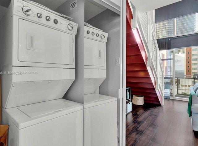 244 Biscayne Blvd Unit 440, Miami, FL 33132 - laundry room featuring stacked washer and clothes dryer and wood finished floors
