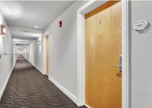 244 Biscayne Blvd Unit 440, Miami, FL 33132 - hallway featuring dark carpet and baseboards