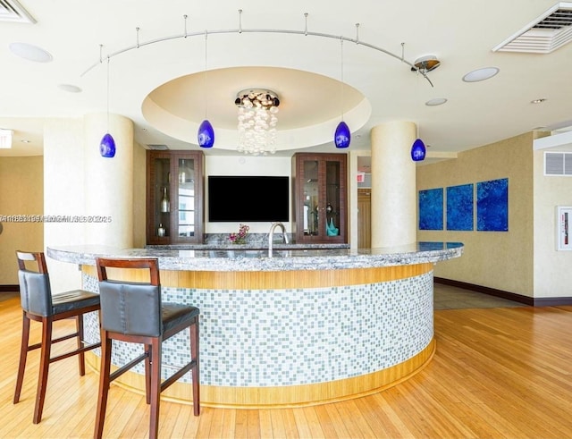 244 Biscayne Blvd Unit 440, Miami, FL 33132 - bar with light wood finished floors and pendant lighting