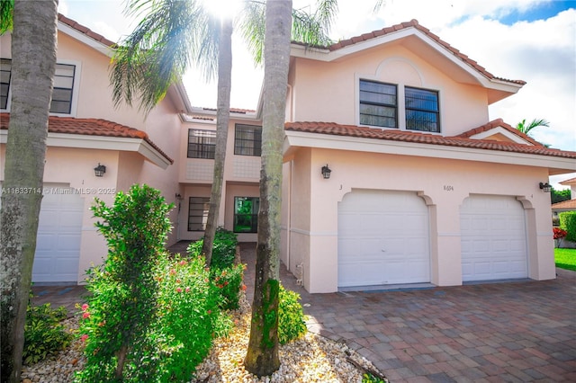 8694 Via Reale Unit 61L, Boca Raton, FL 33496 - view of front of property featuring a tiled roof, stucco siding, and driveway