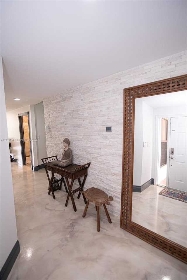 8694 Via Reale Unit 61L, Boca Raton, FL 33496 - hallway with baseboards and concrete floors