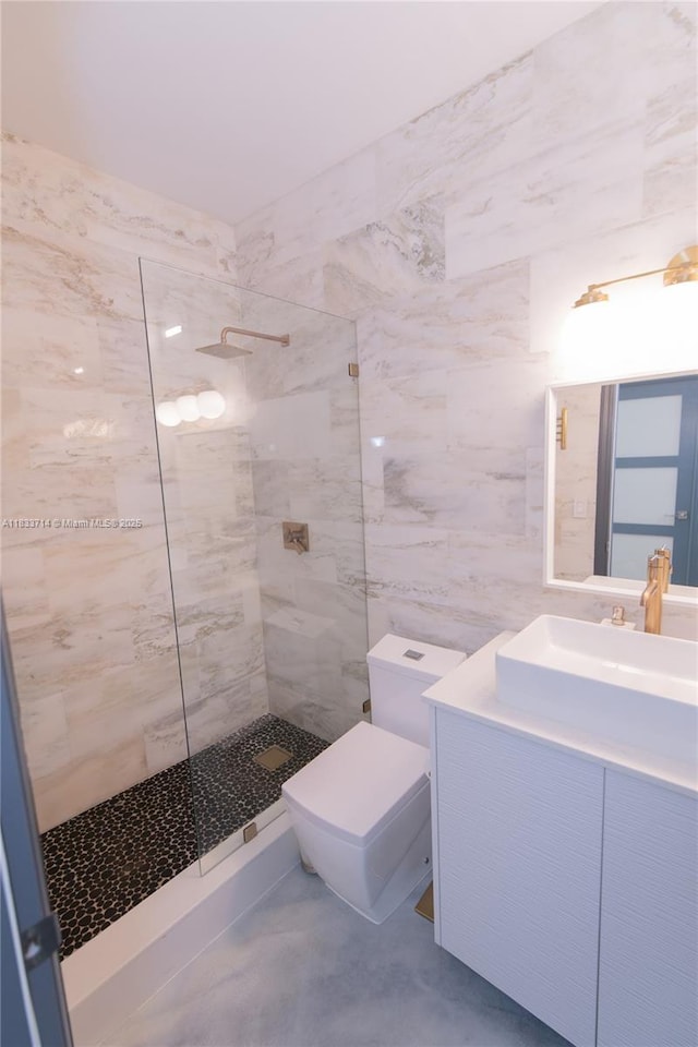 8694 Via Reale Unit 61L, Boca Raton, FL 33496 - bathroom featuring a walk in shower, vanity, tile walls, and concrete flooring