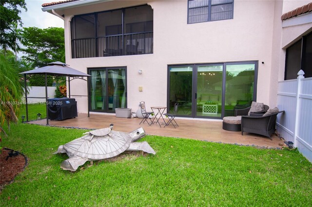 8694 Via Reale Unit 61L, Boca Raton, FL 33496 - rear view of property with stucco siding and a patio