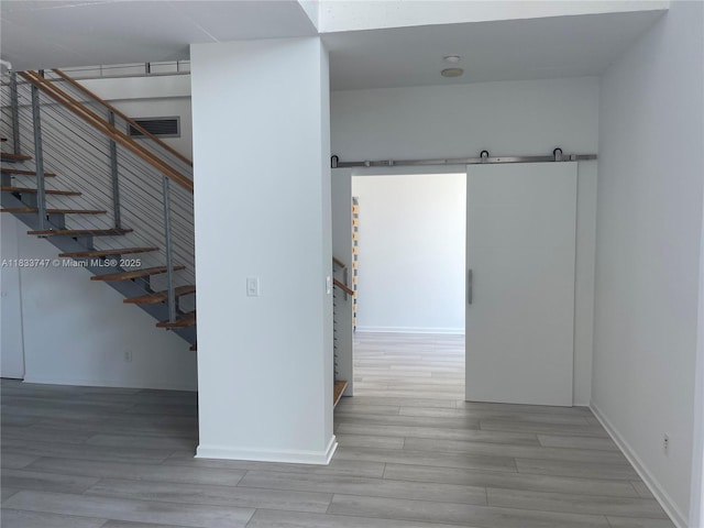 690 SW 1st Ct Unit 19, Miami, FL 33130 - corridor with a barn door, stairway, and wood finished floors