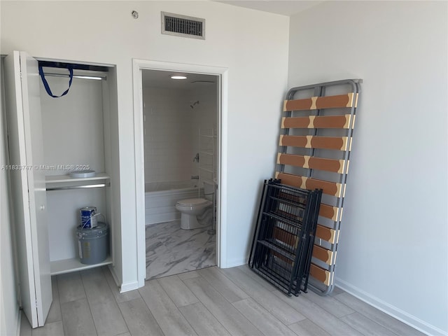 690 SW 1st Ct Unit 19, Miami, FL 33130 - bedroom with wood finish floors and ensuite bathroom