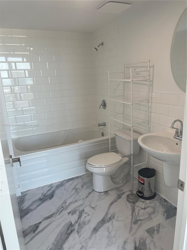 690 SW 1st Ct Unit 19, Miami, FL 33130 - full bathroom featuring  shower combination, marble finish floors, and tile walls