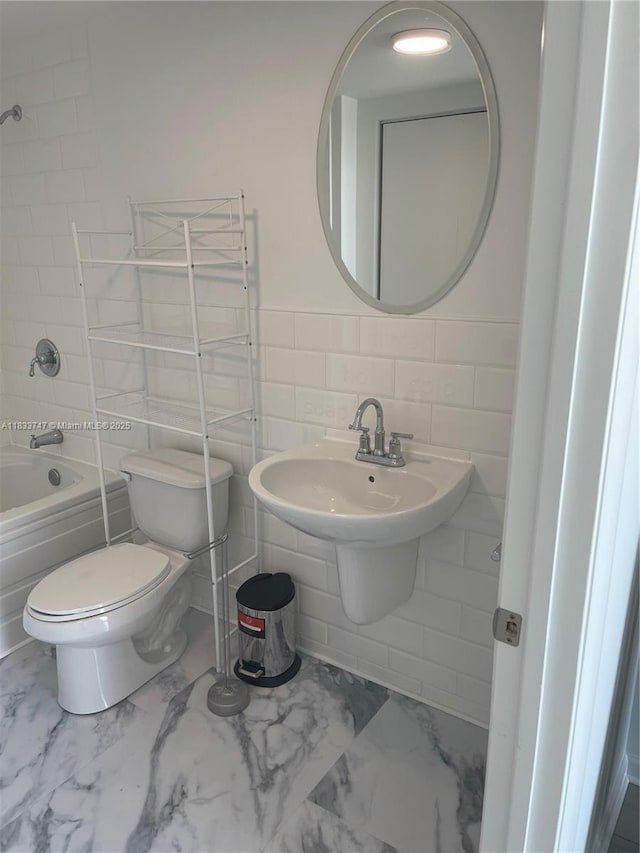 690 SW 1st Ct Unit 19, Miami, FL 33130 - full bathroom featuring marble finish flooring, shower / bath combination, and tile walls