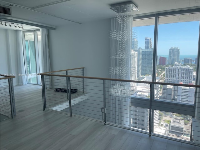 690 SW 1st Ct Unit 19, Miami, FL 33130 - spare room with wood finished floors, expansive windows, and a view of skyline