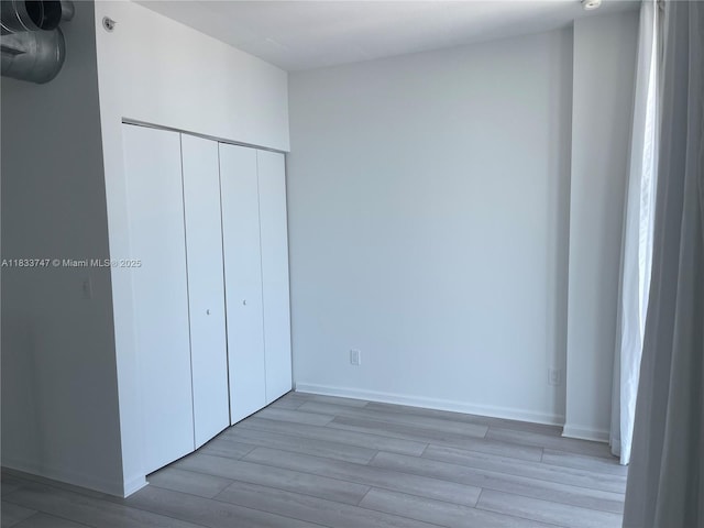 690 SW 1st Ct Unit 19, Miami, FL 33130 - unfurnished bedroom featuring wood finished floors and a closet