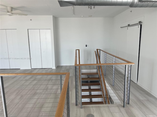 690 SW 1st Ct Unit 19, Miami, FL 33130 - stairs with wood finished floors, ceiling fan, and a barn door