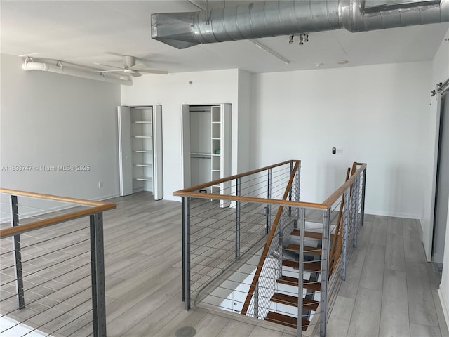 690 SW 1st Ct Unit 19, Miami, FL 33130 - hallway featuring an upstairs landing and wood finished floors