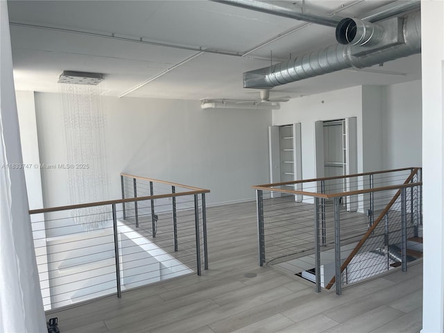 690 SW 1st Ct Unit 19, Miami, FL 33130 - hallway with an upstairs landing and wood finished floors