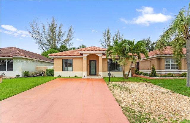 5400 NW 184th St, Miami Gardens, FL 33055 - mediterranean / spanish house with a tile roof, stucco siding, a front yard, and driveway