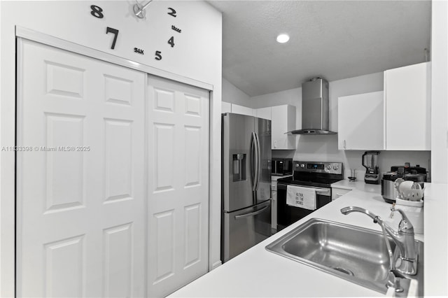5400 NW 184th St, Miami Gardens, FL 33055 - kitchen with wall chimney range hood, stainless steel appliances, white cabinets, light countertops, and a textured ceiling
