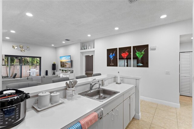 5400 NW 184th St, Miami Gardens, FL 33055 - kitchen with recessed lighting, light countertops, light tile patterned flooring, open floor plan, and a textured ceiling