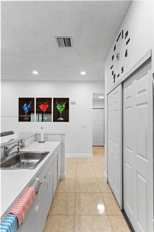 5400 NW 184th St, Miami Gardens, FL 33055 - kitchen featuring light tile patterned floors, recessed lighting, light countertops, a textured ceiling, and dishwashing machine