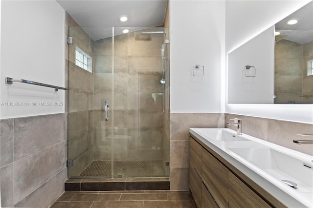 5400 NW 184th St, Miami Gardens, FL 33055 - bathroom with tile walls, a shower stall, double vanity, tile patterned flooring, and recessed lighting