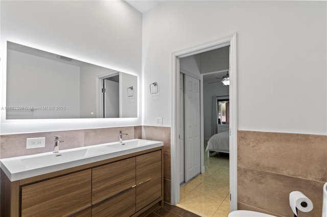 5400 NW 184th St, Miami Gardens, FL 33055 - ensuite bathroom featuring double vanity, tile patterned flooring, and wainscoting