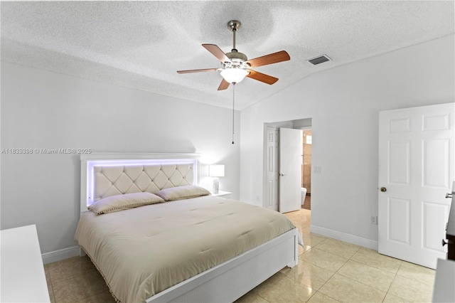 5400 NW 184th St, Miami Gardens, FL 33055 - bedroom featuring vaulted ceiling, a textured ceiling, light tile patterned flooring, ensuite bath, and a ceiling fan