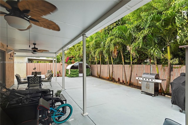 5400 NW 184th St, Miami Gardens, FL 33055 - fenced backyard with a grill, ceiling fan, outdoor dining space, and a patio area