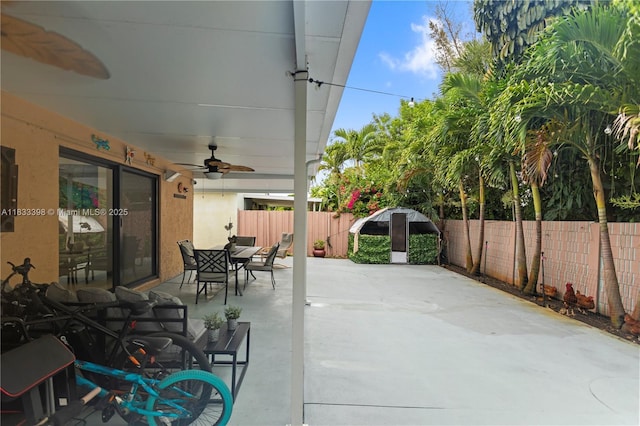 5400 NW 184th St, Miami Gardens, FL 33055 - fenced backyard with a ceiling fan, outdoor dining space, and a patio