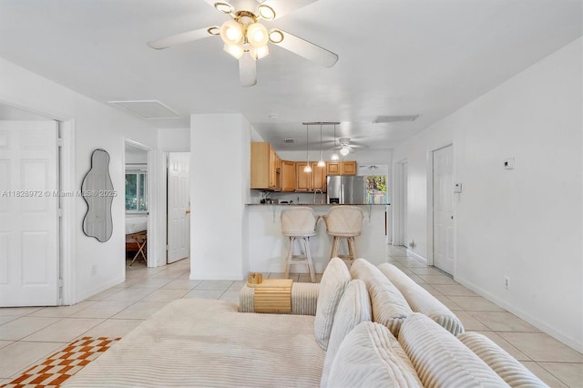 220 NW 35th Ct, Oakland Park, FL 33309 - living area with ceiling fan, light tile patterned flooring, and attic access