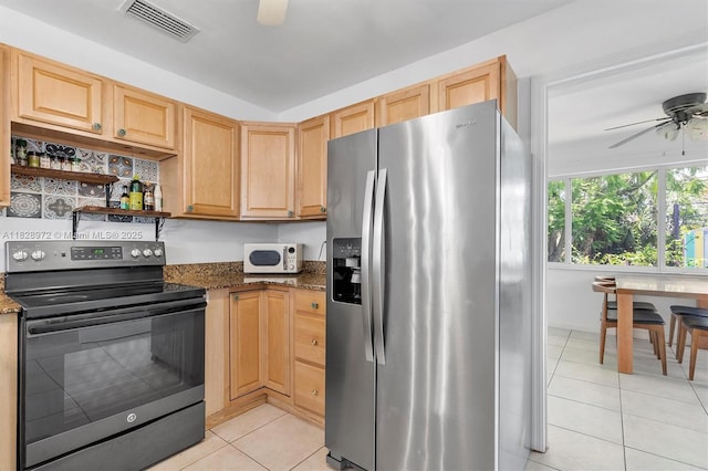 220 NW 35th Ct, Oakland Park, FL 33309 - kitchen with stainless steel fridge, black / electric stove, a ceiling fan, light tile patterned flooring, and dark stone countertops