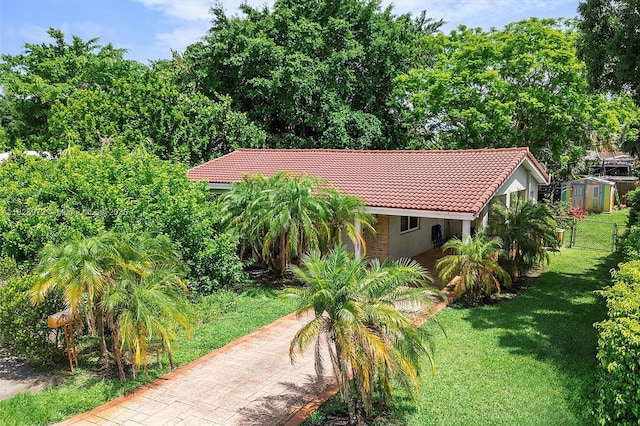 220 NW 35th Ct, Oakland Park, FL 33309 - view of front of house with a tile roof and a storage shed