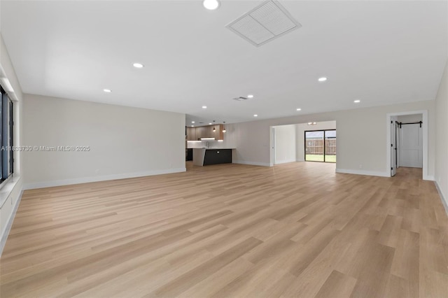 1340 SW 27th Pl, Boynton Beach, FL 33426 - unfurnished living room with light wood finished floors and recessed lighting