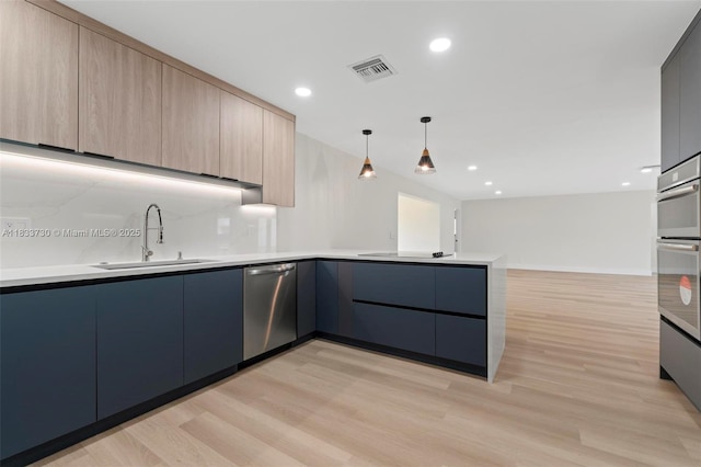 1340 SW 27th Pl, Boynton Beach, FL 33426 - kitchen featuring stainless steel dishwasher, modern cabinets, a peninsula, light wood finished floors, and recessed lighting
