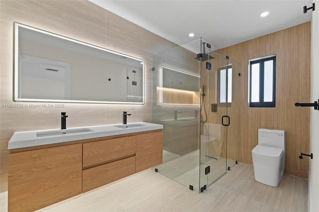 1340 SW 27th Pl, Boynton Beach, FL 33426 - bathroom with tile walls, double vanity, a stall shower, tile patterned floors, and recessed lighting