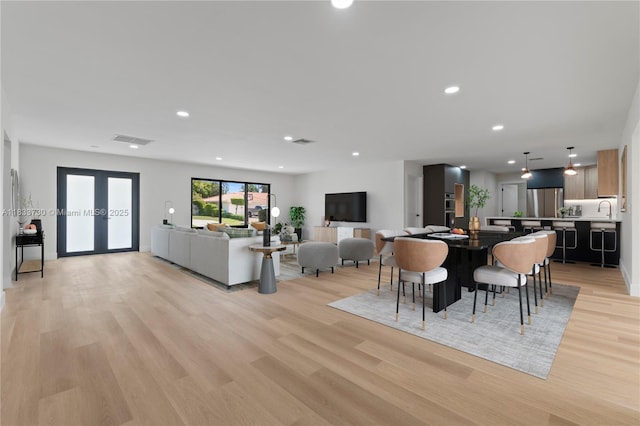 1340 SW 27th Pl, Boynton Beach, FL 33426 - dining space with light wood-type flooring, recessed lighting, and french doors