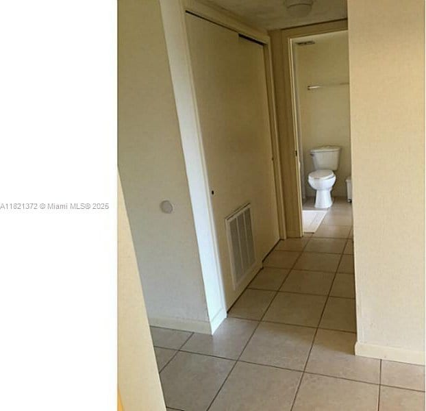7900 Camino Crk Unit 401, Miami, FL 33143 - hall featuring light tile patterned floors and baseboards