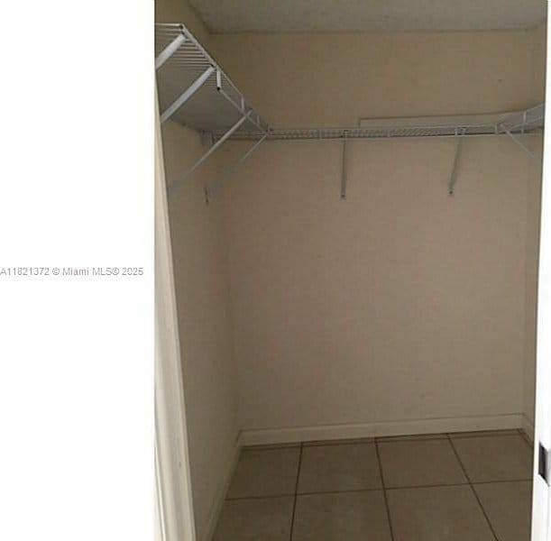 7900 Camino Crk Unit 401, Miami, FL 33143 - walk in closet with tile patterned flooring