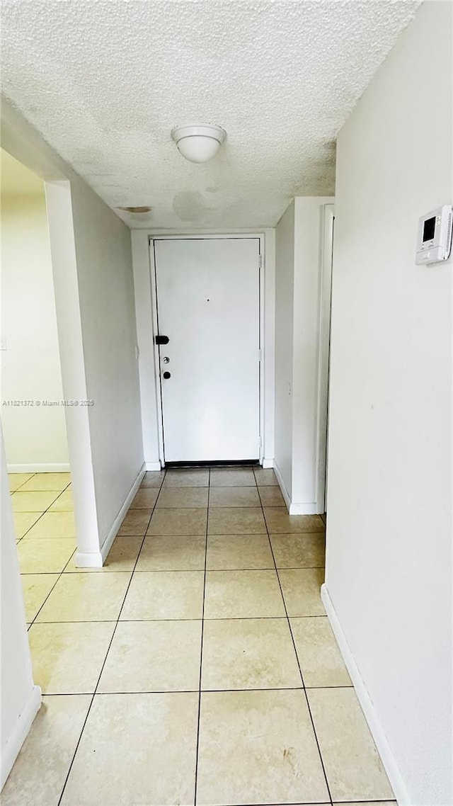 7900 Camino Crk Unit 401, Miami, FL 33143 - corridor featuring light tile patterned floors and a textured ceiling