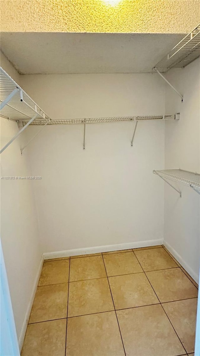 7900 Camino Crk Unit 401, Miami, FL 33143 - spacious closet featuring light tile patterned flooring