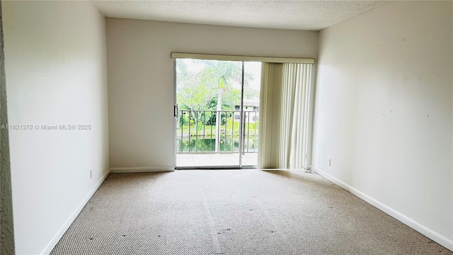 7900 Camino Crk Unit 401, Miami, FL 33143 - carpeted spare room featuring baseboards and a textured ceiling