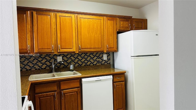 7900 Camino Crk Unit 401, Miami, FL 33143 - kitchen with white appliances, backsplash, dark countertops, and brown cabinetry