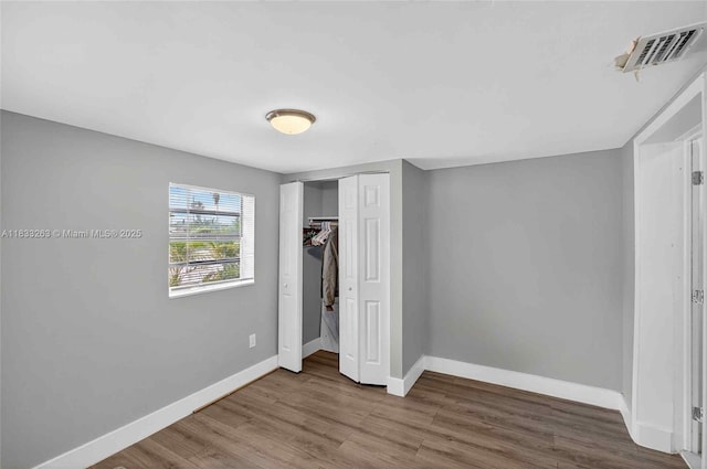 8224 NW 1st Pl, Miami, FL 33150 - unfurnished bedroom with wood finished floors and a closet