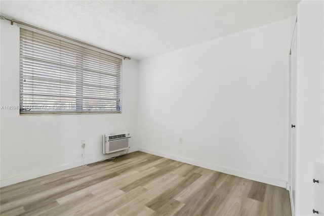 2400 NE 9th St Unit 201, Fort Lauderdale, FL 33304 - spare room with a wall mounted AC and light wood finished floors