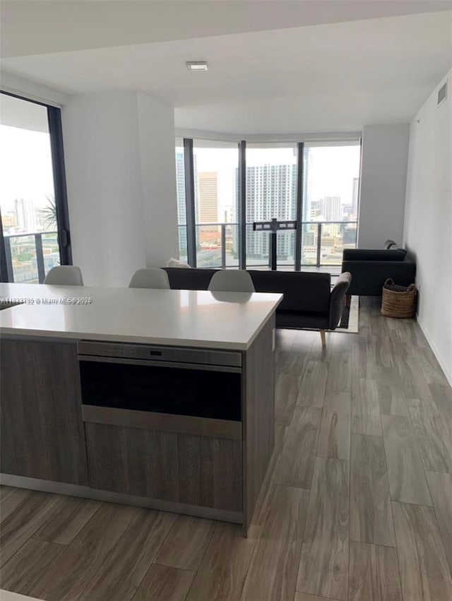 801 S Miami Ave Unit 2609, Miami, FL 33130 - kitchen with light wood-style flooring, light countertops, a center island, and open floor plan