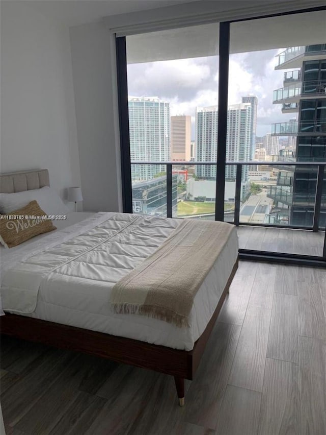 801 S Miami Ave Unit 2609, Miami, FL 33130 - bedroom with a city view, floor to ceiling windows, and wood finished floors