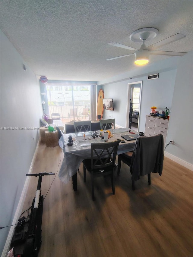 3716 NE 168th St Unit 303, North Miami Beach, FL 33160 - dining space with a textured ceiling, wood finished floors, and ceiling fan