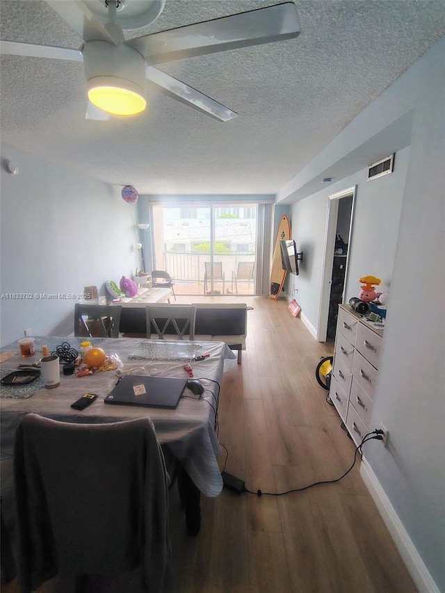 3716 NE 168th St Unit 303, North Miami Beach, FL 33160 - dining room with a textured ceiling, light wood-style floors, and a ceiling fan