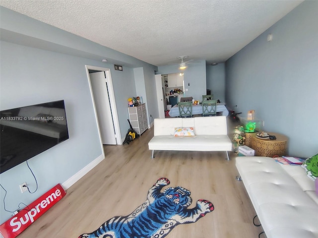 3716 NE 168th St Unit 303, North Miami Beach, FL 33160 - living area with wood finished floors and a textured ceiling