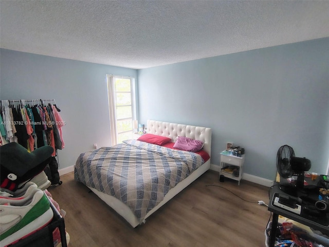 3716 NE 168th St Unit 303, North Miami Beach, FL 33160 - bedroom featuring wood finished floors and a textured ceiling