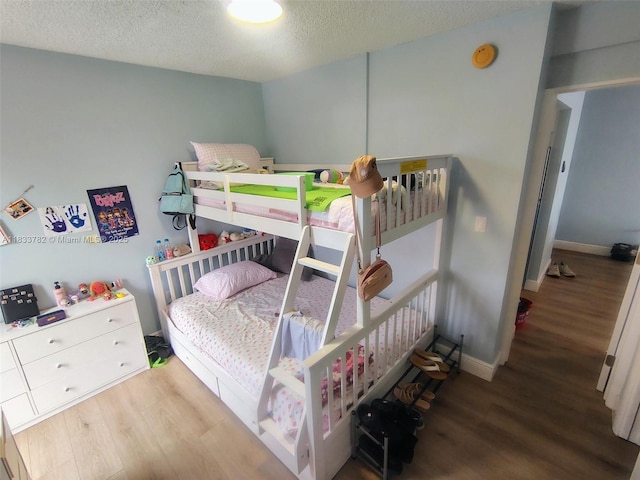 3716 NE 168th St Unit 303, North Miami Beach, FL 33160 - bedroom featuring wood finished floors and a textured ceiling