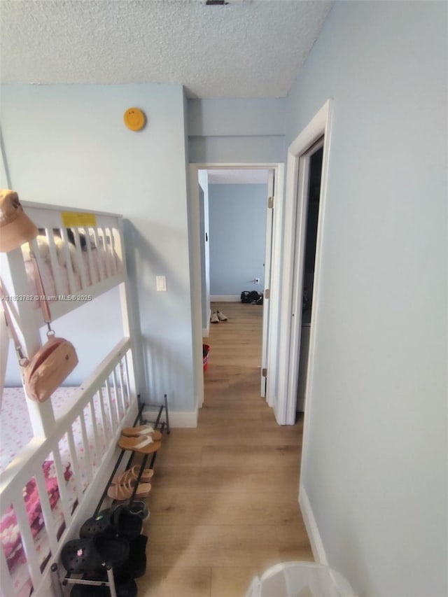 3716 NE 168th St Unit 303, North Miami Beach, FL 33160 - hallway with light wood finished floors and a textured ceiling