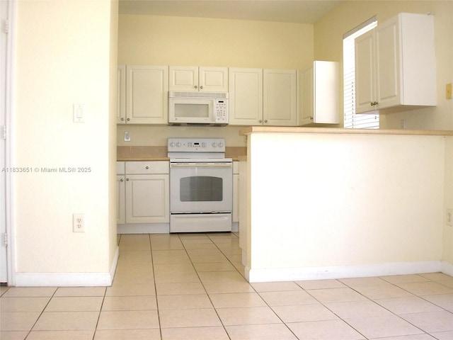 12846 SW 135th St, Miami, FL 33186 - kitchen featuring white appliances, light tile patterned flooring, light countertops, and white cabinets